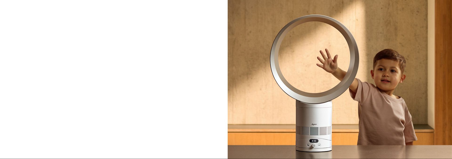 A child putting their hand in the loop of the Dyson Cool CF1 fan.