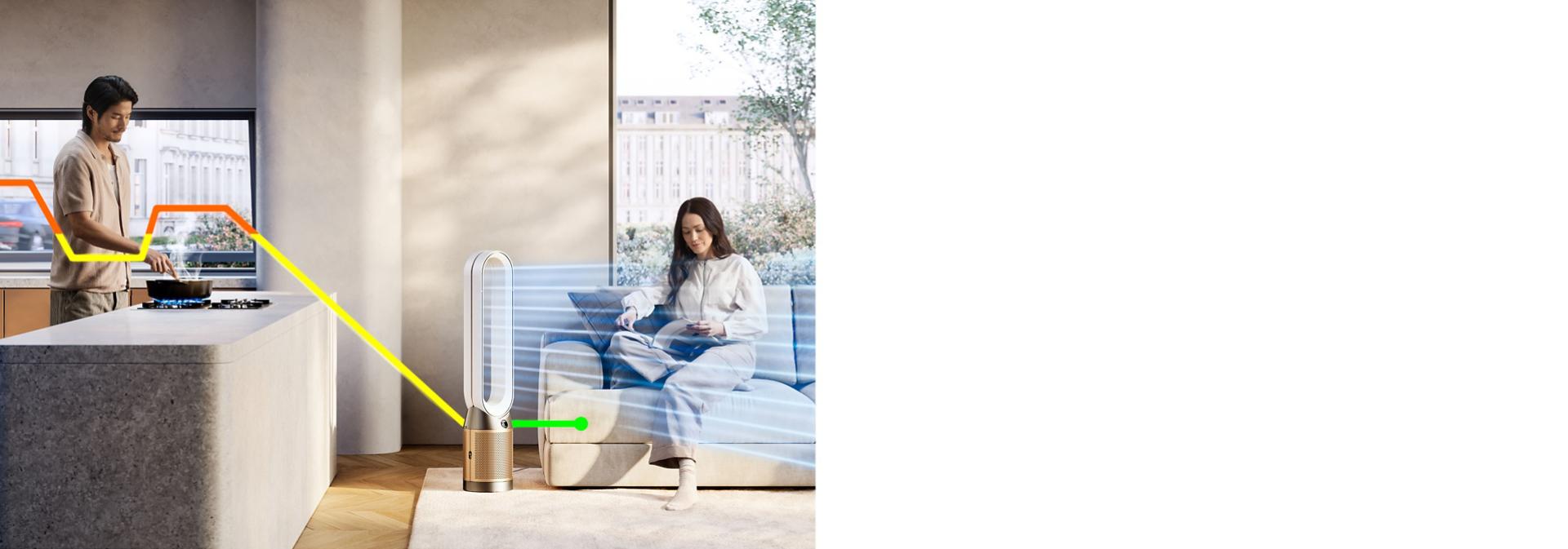 A person cooks in a kitchen while a computer generated line runs from an open window, acrosss the cooking and to a Dyson purifier. It changes from orange to yellow to green as it signifies the improving pollution levels.