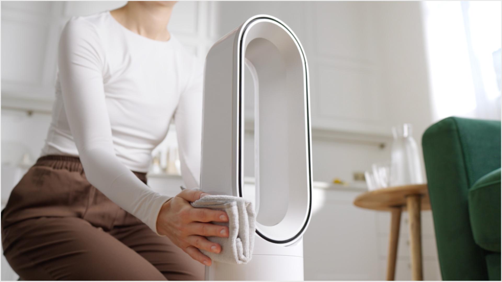 The Dyson Hot+Cool HF1 Remote Link Pre-heat heater and cooling fan is wiped with a cloth.