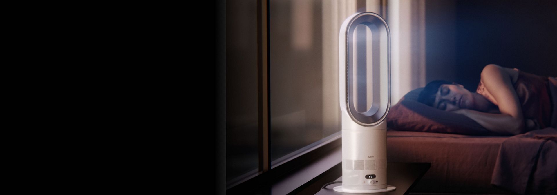 The Dyson Hot+Cool HF1 Remote Link Pre-heat heater and cooling fan operates quietly in a bedroom near a sleeping person.