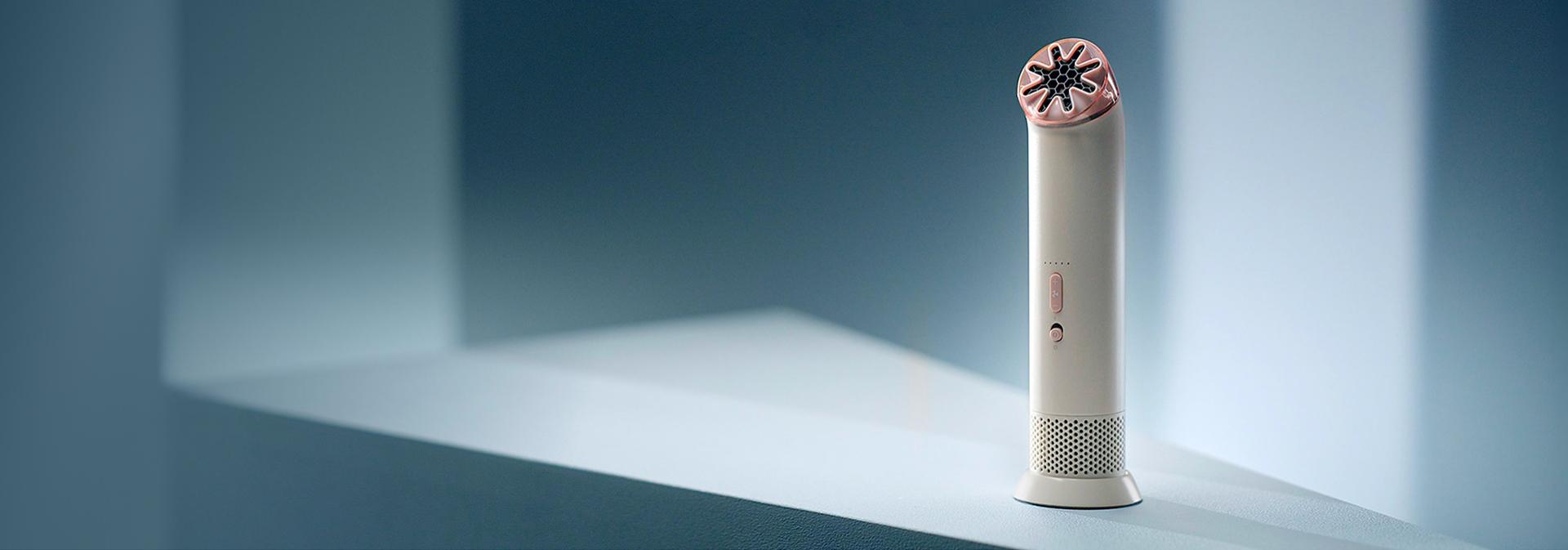 Dyson HushJet Mini Cool fan stood on a desk.