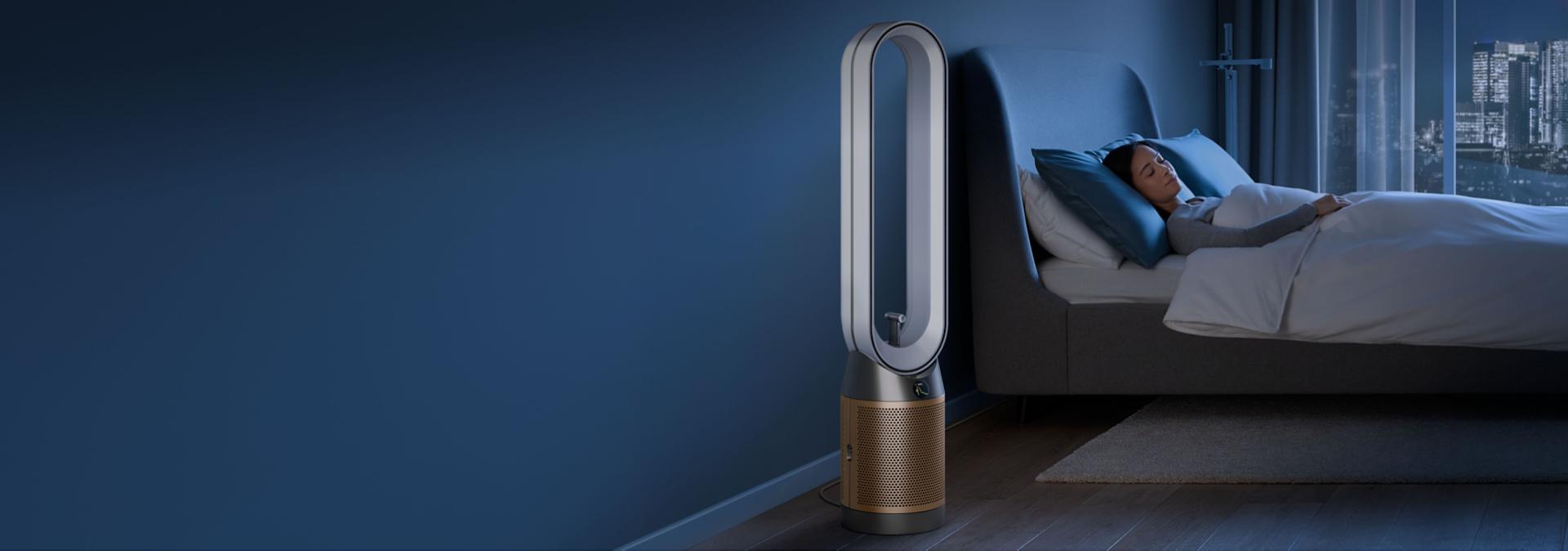 A person sleeps next to their Dyson Find+Follow Purifier Cool fan.