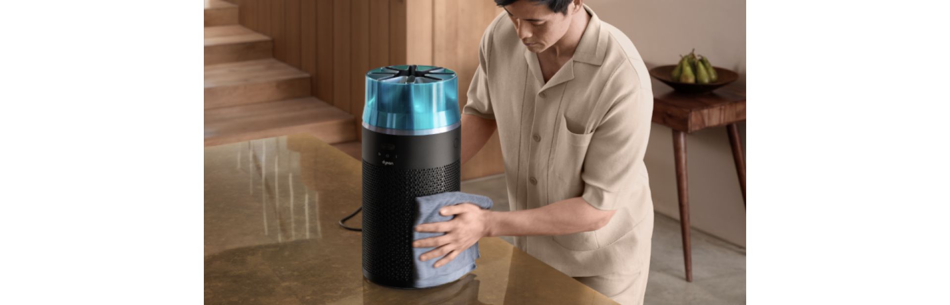 The Dyson HushJet Compact Purifier is wiped down with a cloth to clean.