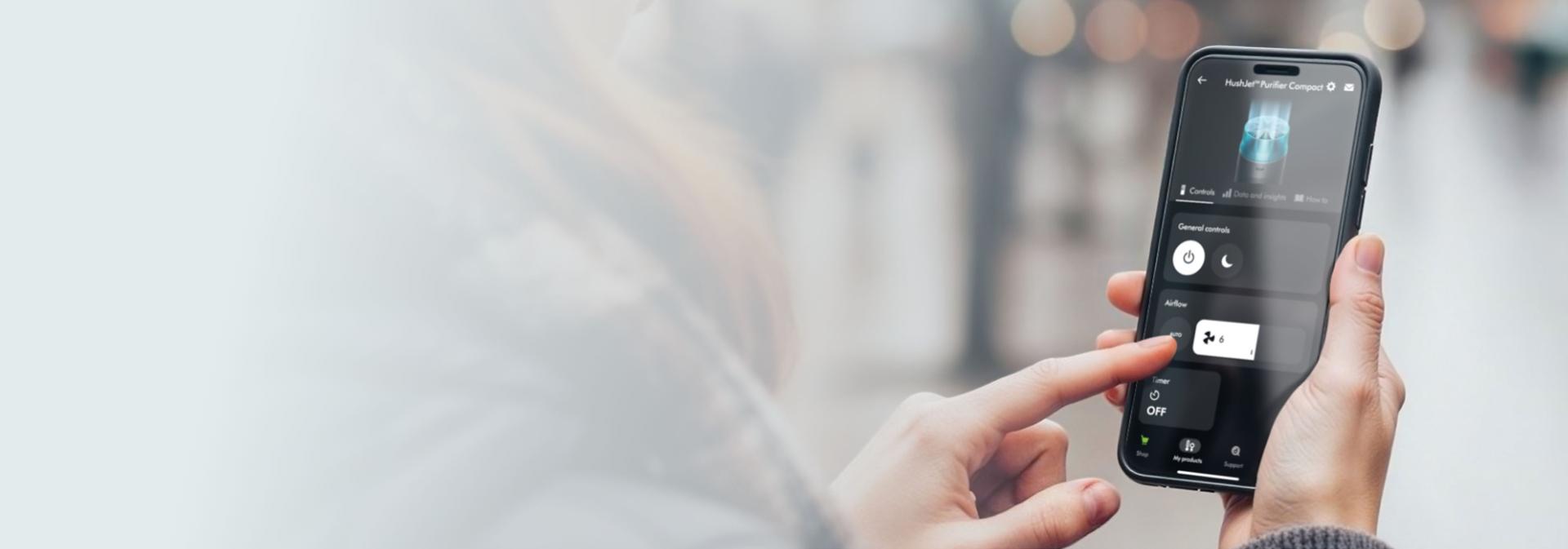 A Dyson Purifier is controlled through the MyDyson app on a phone.