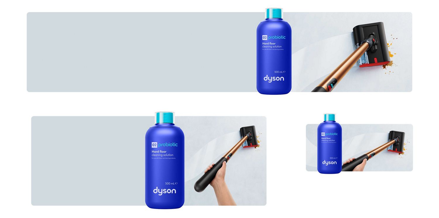 Dyson 02 Probiotic cleaning solution in front of the Dyson PencilWash wet floor cleaner cleaning a spillage on a hard floor.