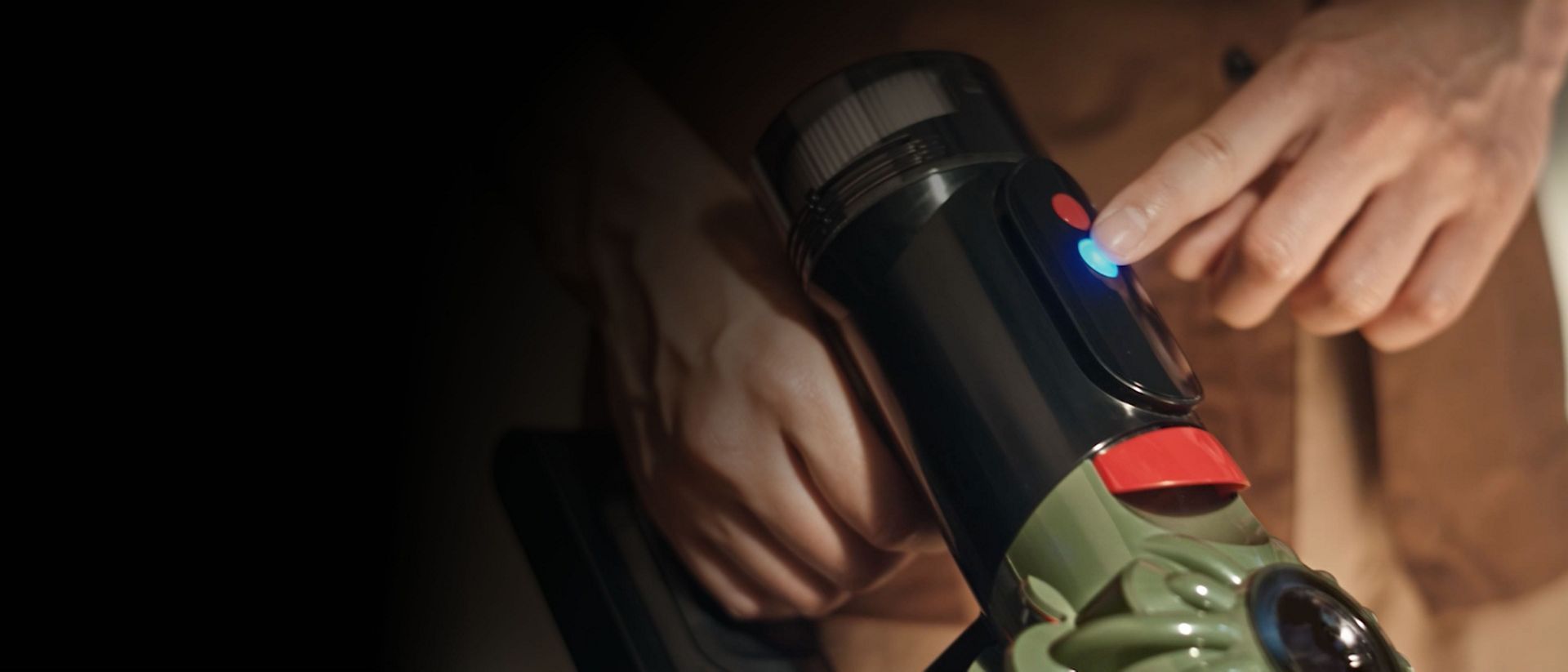 The power mode control button on the top of the Dyson V8 Cyclone vacuum cleaner.