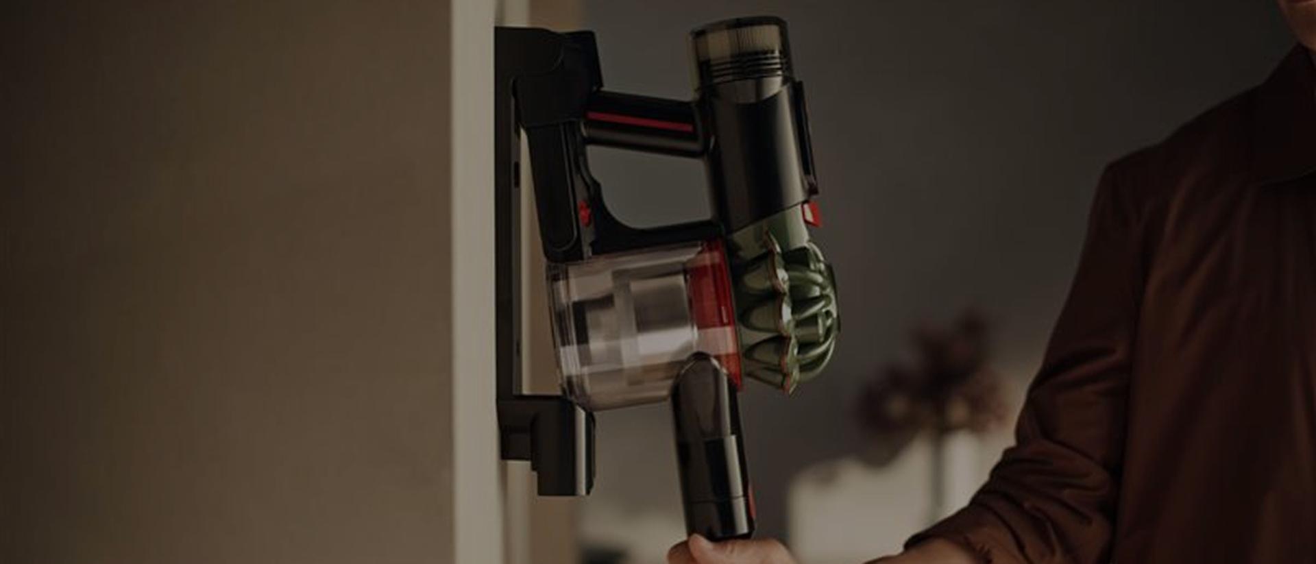 The Dyson V8 Cyclone cordless vacuum is retrieved from its Wall dock.