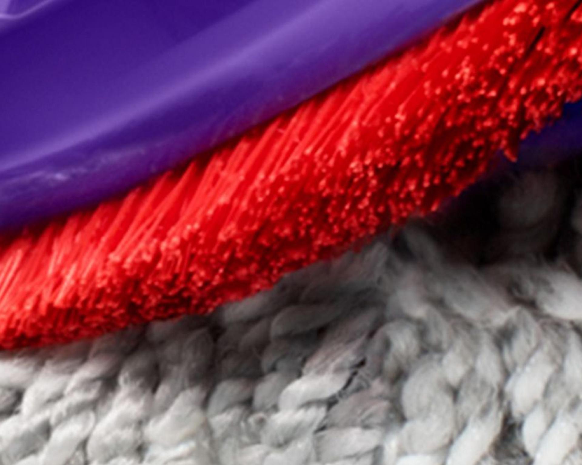 Close-up of the nylon bristles on the Motorbar cleaner head as they dig into carpet.