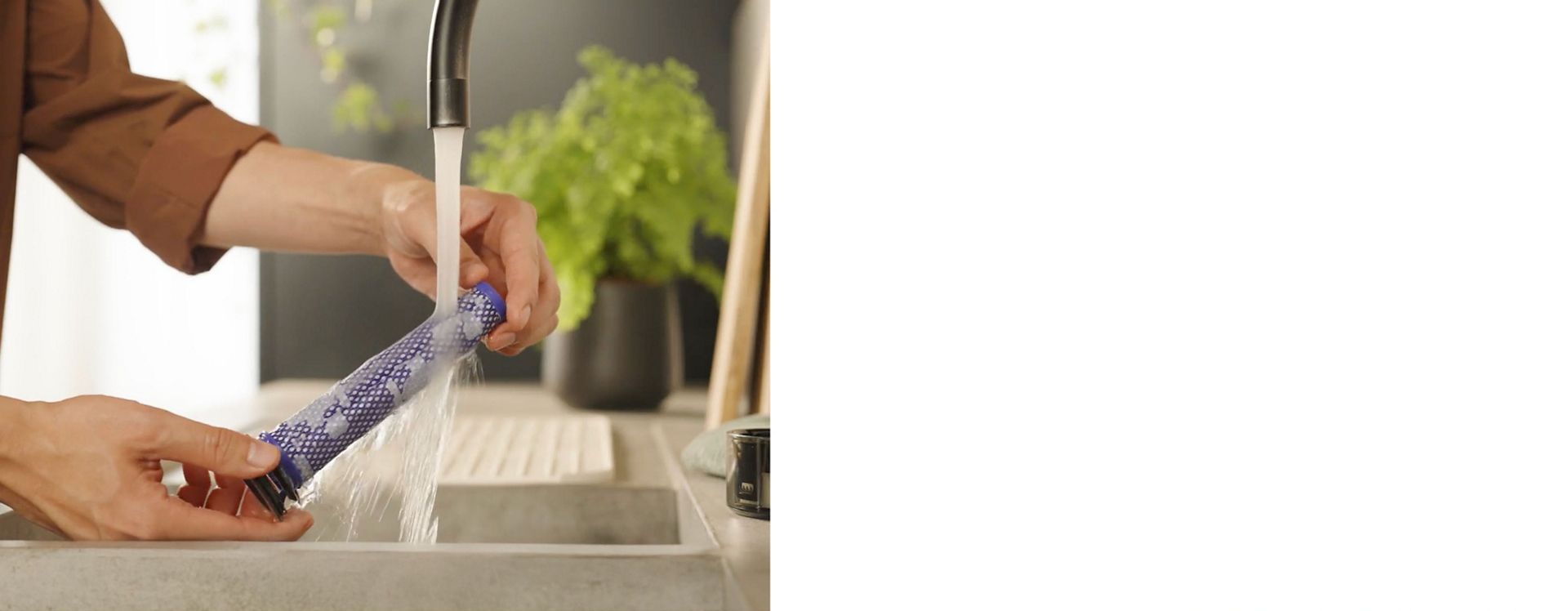 The Pre-filter of the Dyson V8 Cyclone vacuum is cleaned under running water.