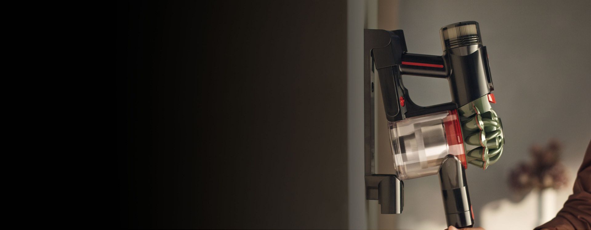 The Dyson V8 Cyclone vacuum is returned to its charging dock.