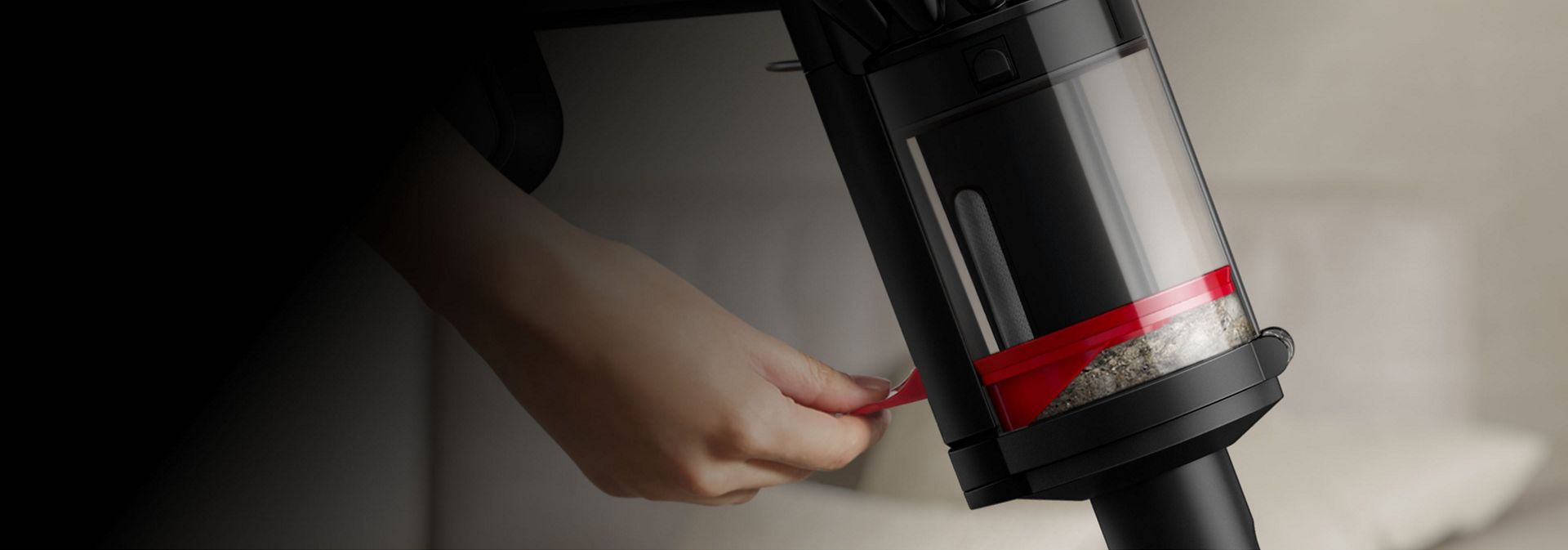A person compressing dirt inside the bin of the Dyson Piston Animal vacuum.