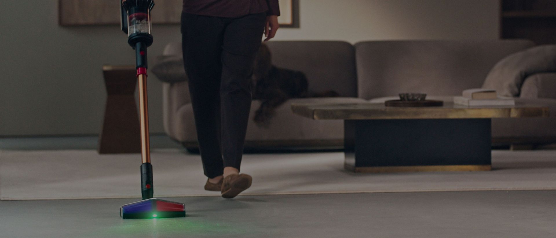 A  close-up of the All Floor Cones Sense cleaner head  illuminating dust on hard floors.