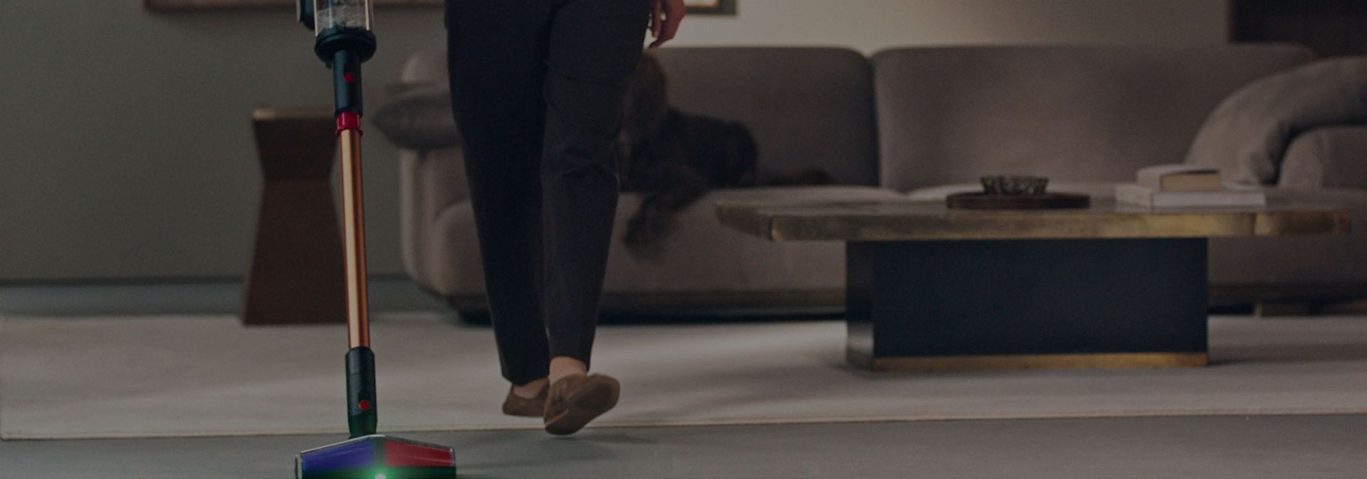 A close-up of the All Floor Cones Sense cleaner head  illuminating dust on hard floors.