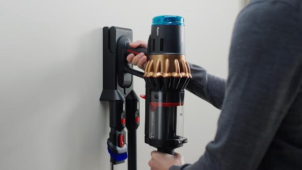 The Dyson DS60 Piston Animal vacuum is placed onto its Wall dock to charge.