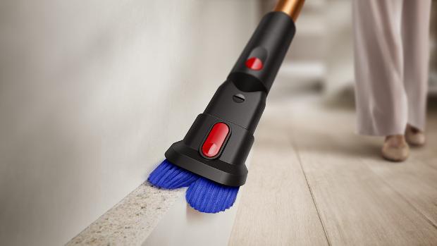 The combi tool of the Dyson Piston Animal vacuum being used to clean a skirting board.