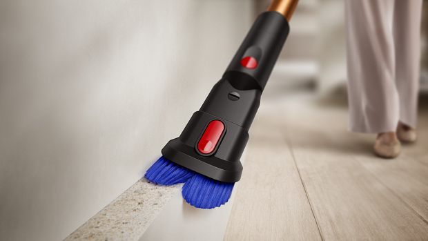 The combi tool of the Dyson Piston Animal vacuum being used to clean a skirting board.