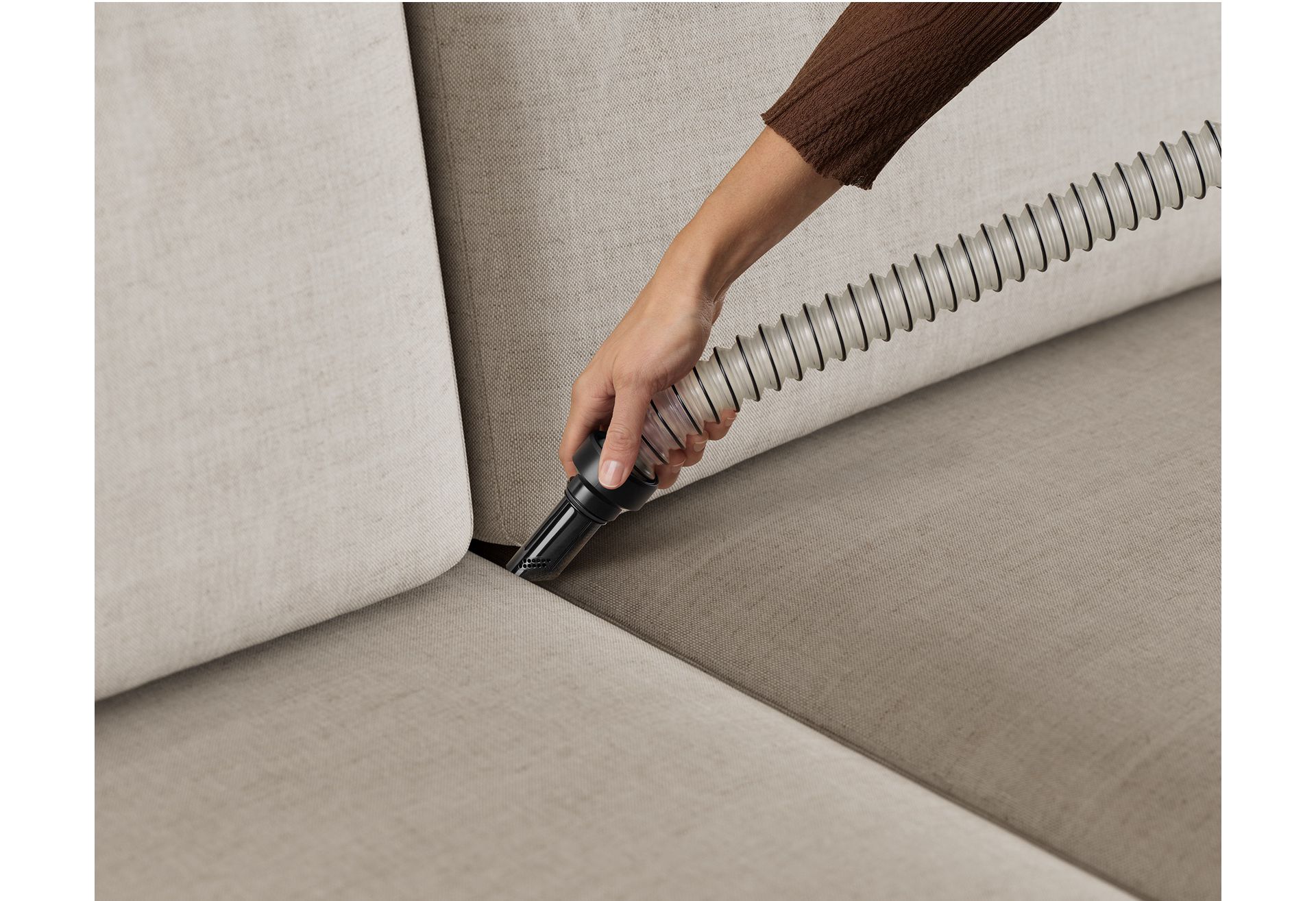 The Flexi hose tool is used to more easily clean between sofa cushions.