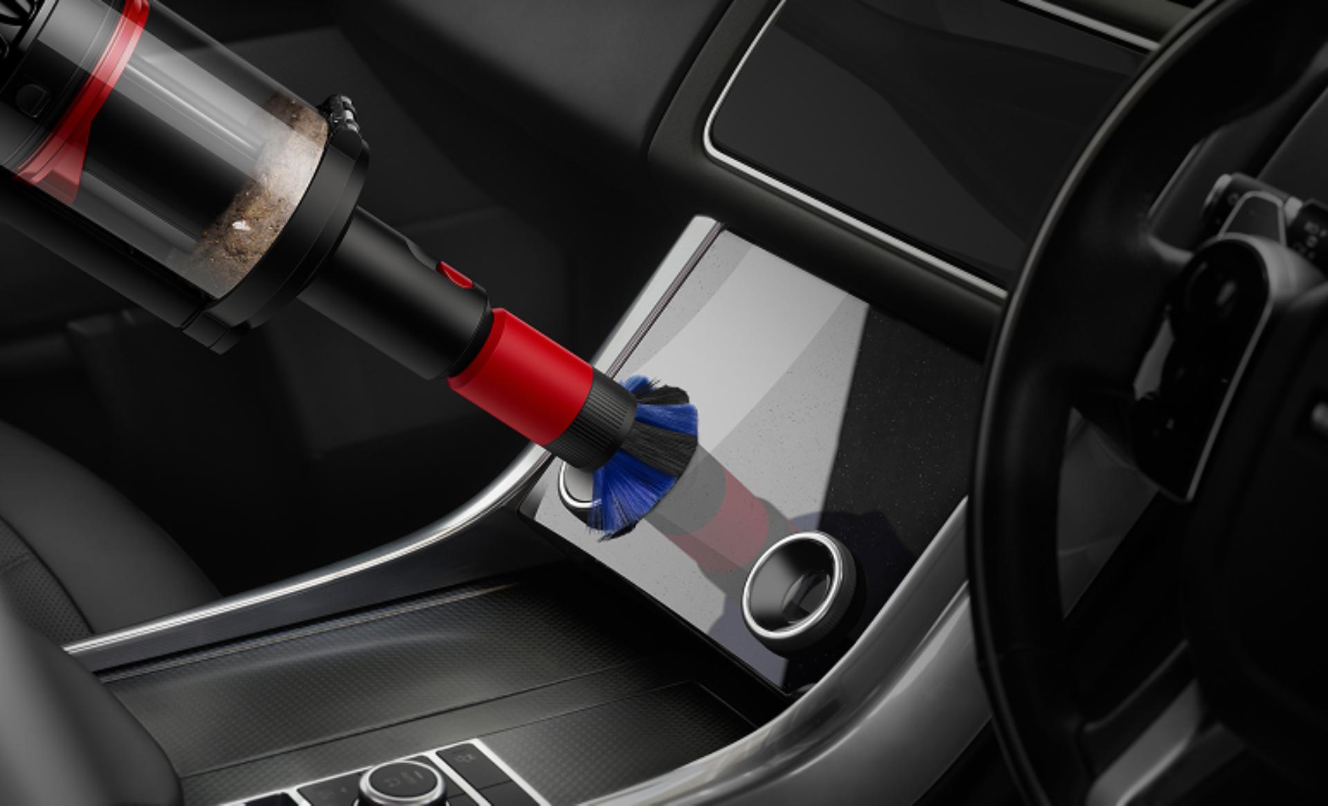 The Scratch-free dusting brush is used to clean a screen in a car.