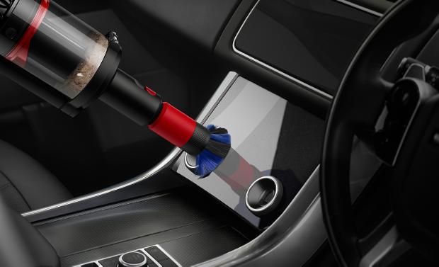 The Scratch-free dusting brush is used to clean a screen in a car.
