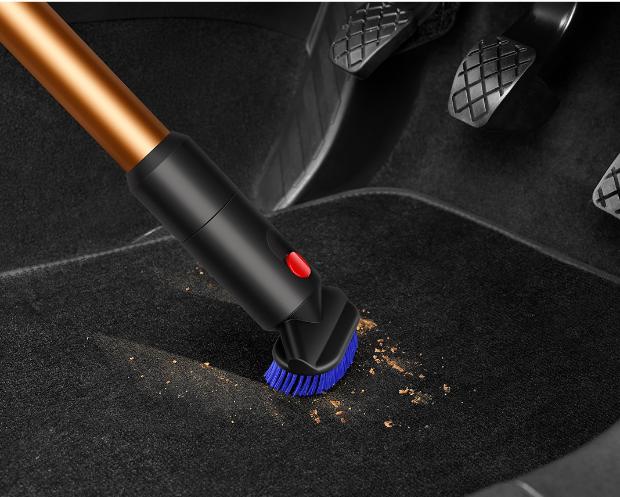 The Stubborn dirt brush is used to clean a car mat.