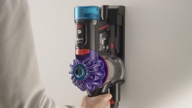 The Dyson V10 vacuum is placed into its Wall Dok.