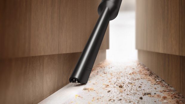 The Crevice tool used to clean a gap between cabinets.