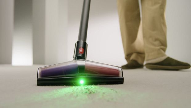 Dyson De-tangling conical head illuminates and cleans dust from a hard floor.