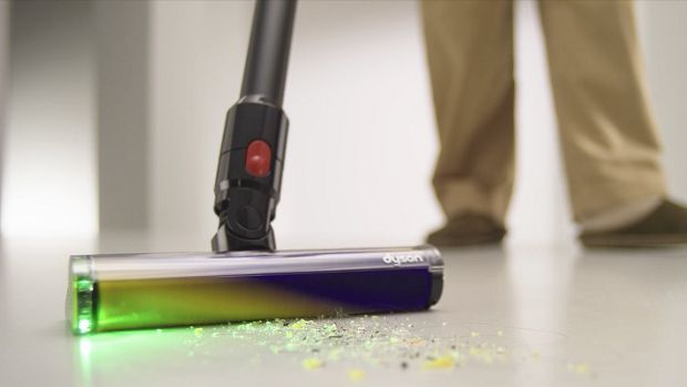 Dyson Fluffy Optic cleaner head illuminates and cleans dust from a hard floor.