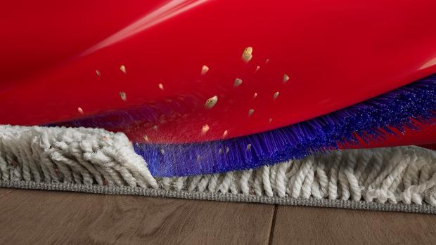 Close-up of the Conical head’s brush bar as it cleans a carpet.