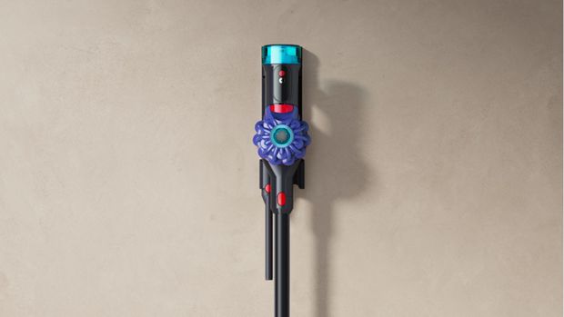 The Dyson Cyclone V10 cordless vacuum in its wall dock.