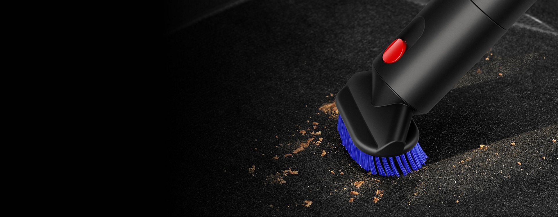 Dyson Stubborn dirt brush used to clean a car foot mat.