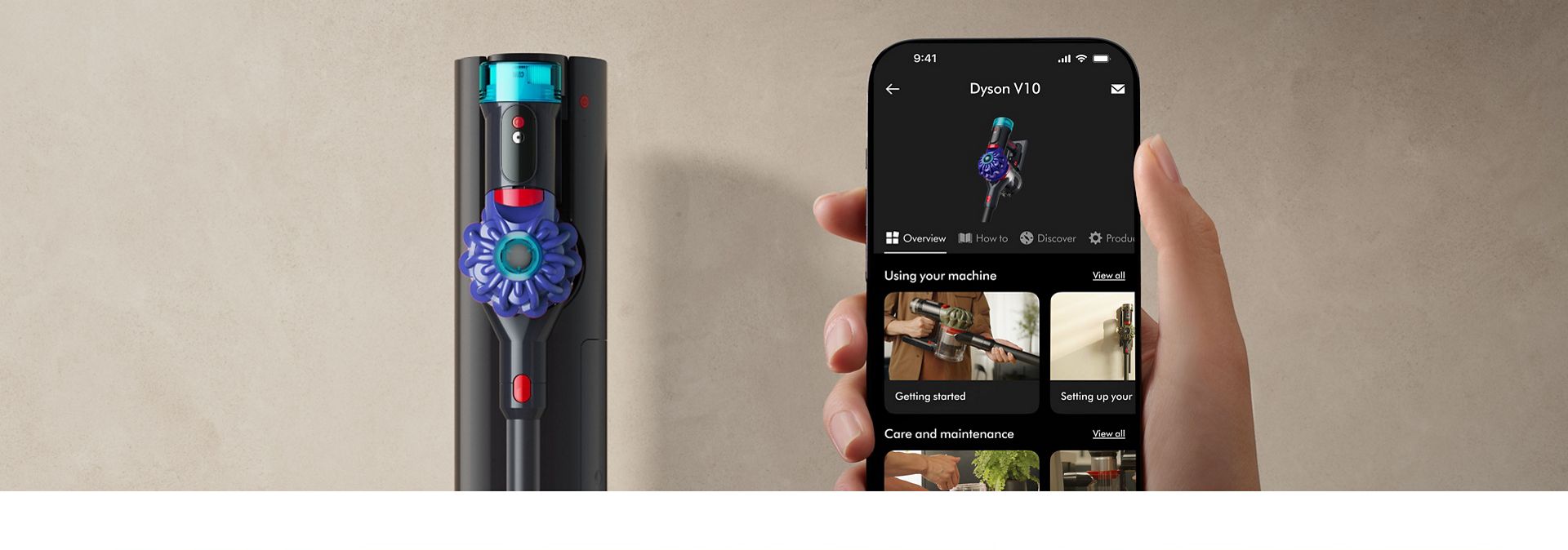 The Dyson Cyclone V10 cordless vacuum in the Auto-empty Dok next to a phone showing the MyDyson app.