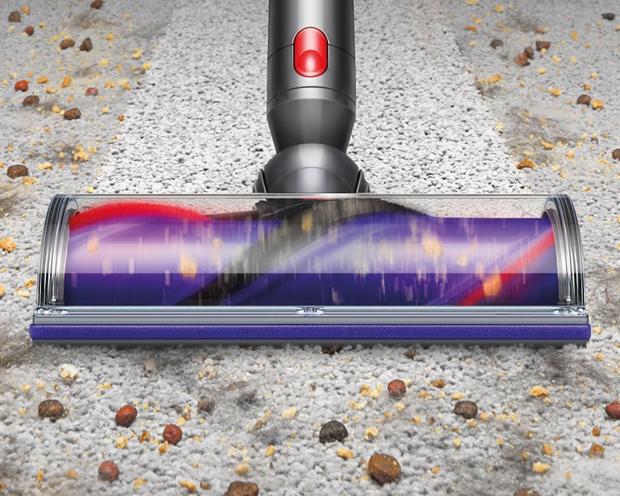 The Dyson Digital Motorbar head cleaning debris from carpet.