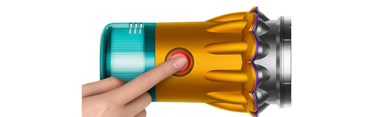 A person presses the power button on the Dyson V12s Detect Slim Submarine Complete vacuum cleaner.