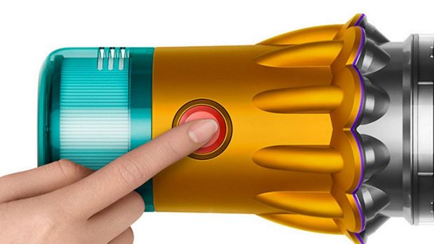 A model pressing the power button on the Dyson V12s Detect Slim Submarine Complete wet and dry vacuum.