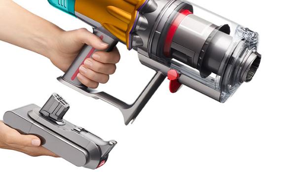 A model swapping the battery on the Dyson V12s Detect Slim Submarine Complete wet and dry vacuum.