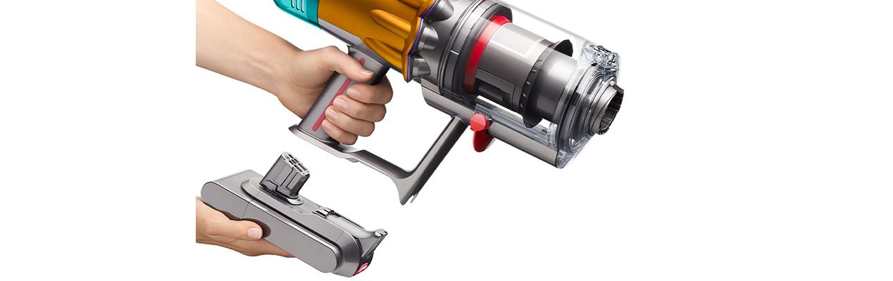 A person replaces the battery on the Dyson V12s Detect Slim Submarine Complete vacuum cleaner.