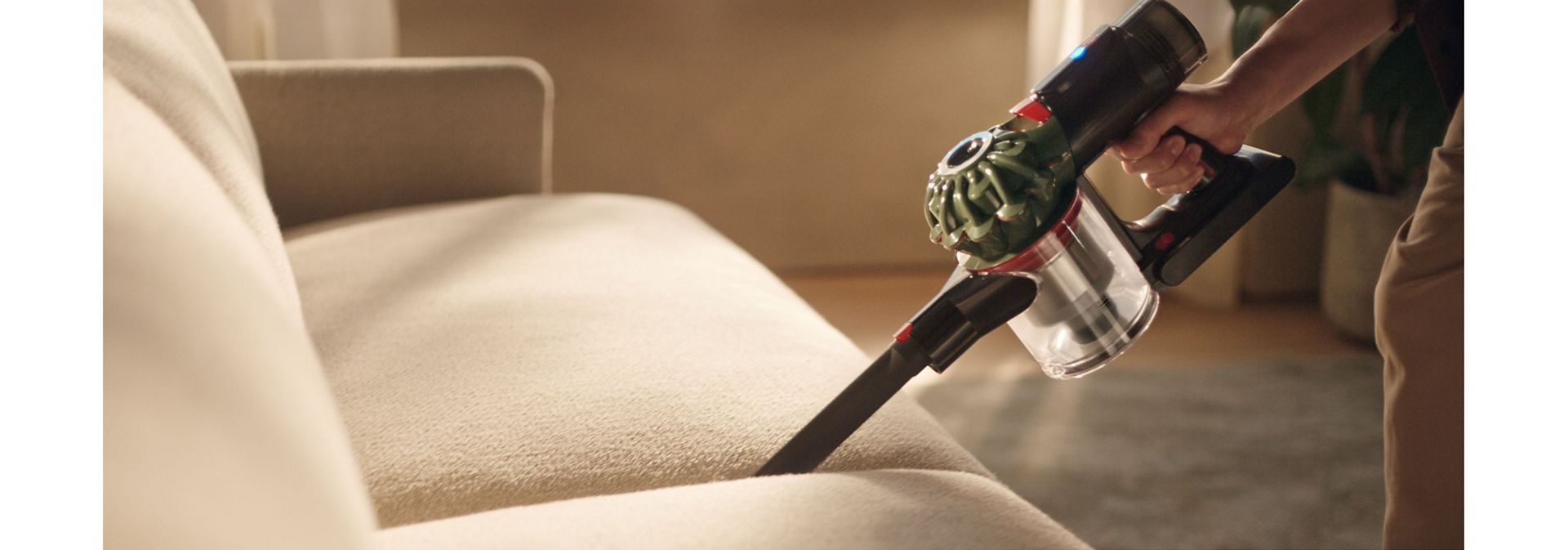 Dyson V8 Cyclone vacuum used to clean between cushions.