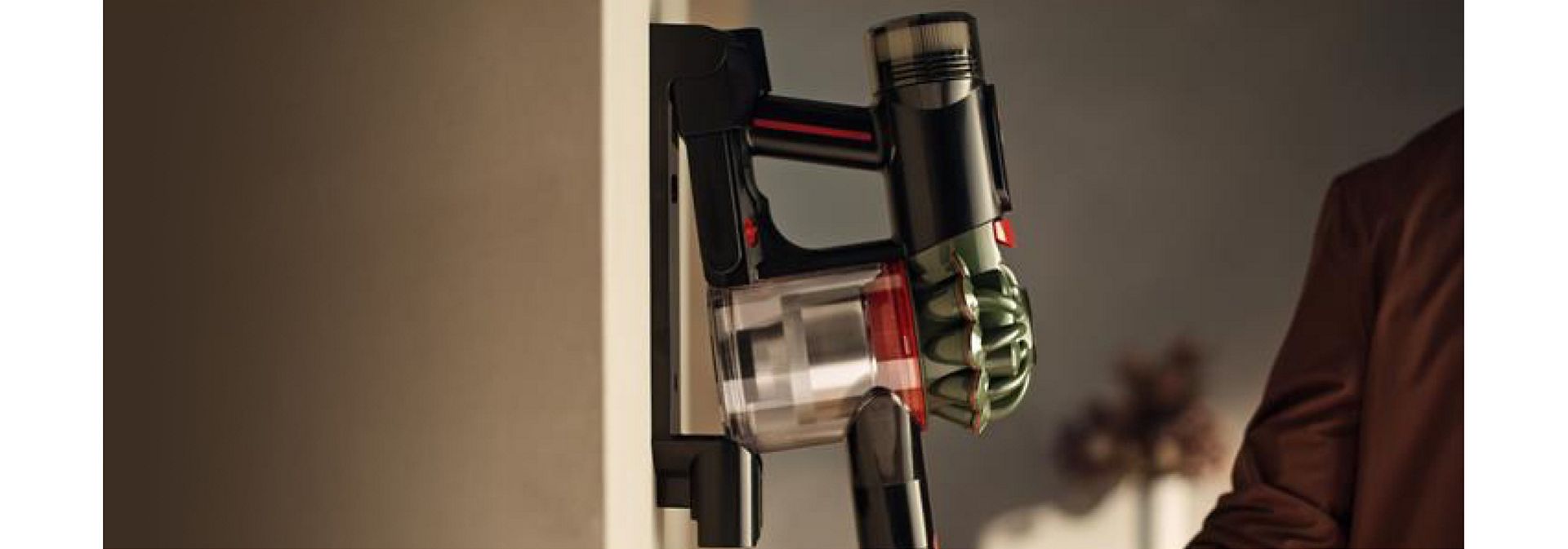 Dyson V8 Cyclone vacuum placed in the wall-mounted dock after use.