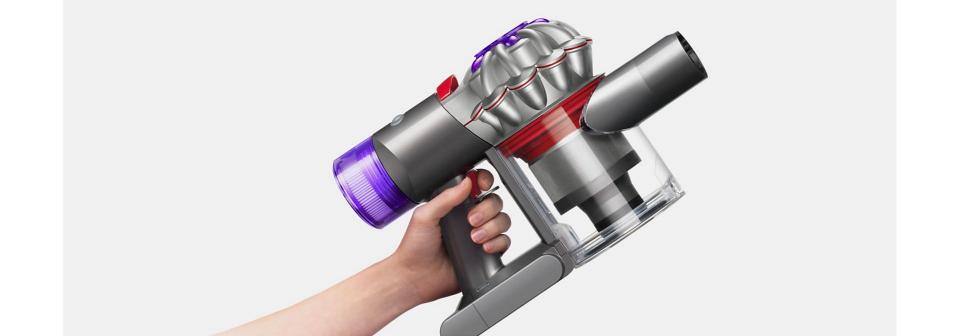 Dyson V8 vacuum held in a hand.