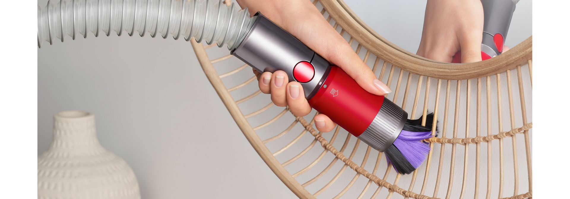 Dyson V8 Focus Clean handheld vacuum used to dust a surface.