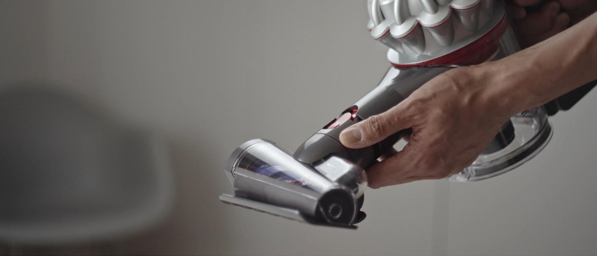Hair screw tool is attached to the Dyson V8 Focus Clean handheld vacuum.