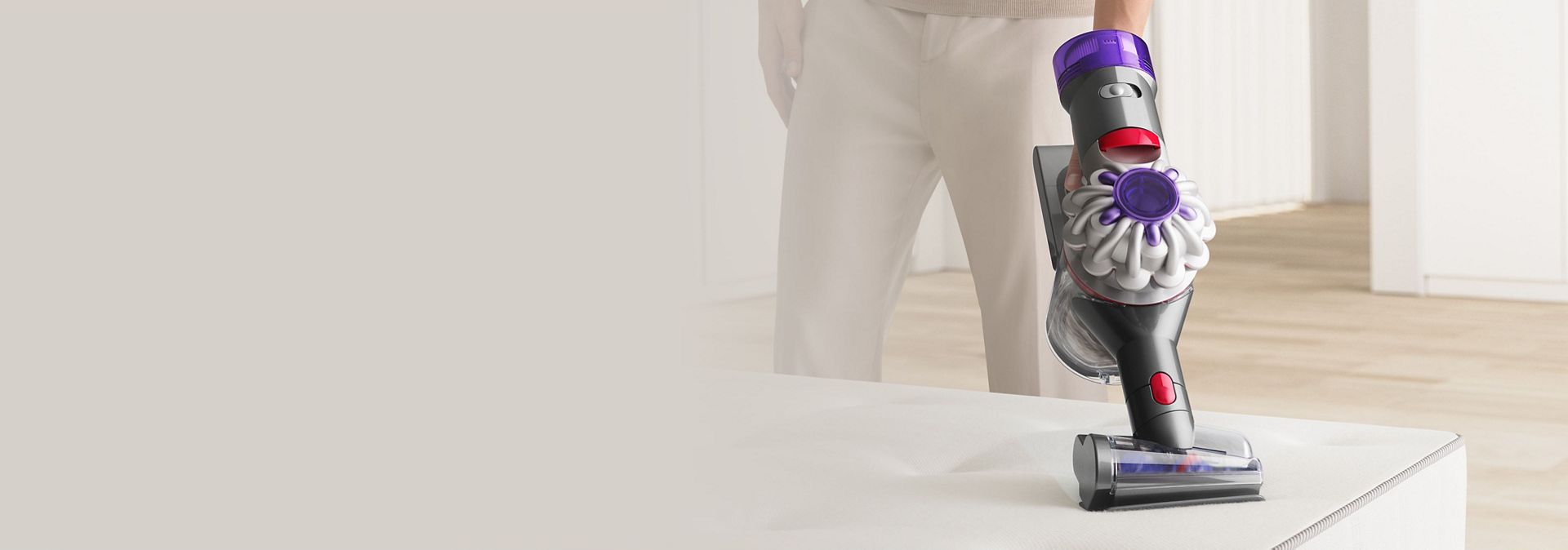 Dyson V8 Focus Clean handheld vacuum used to clean upholstery.