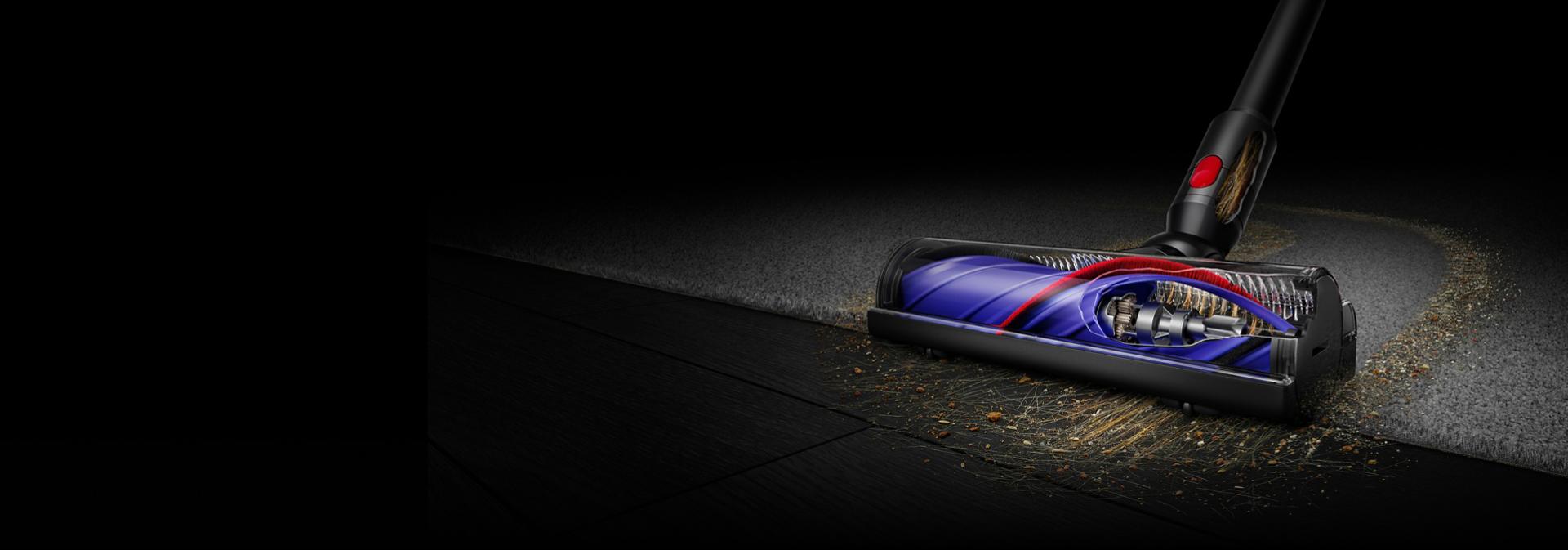 Dyson Motorbar cleaner head used to clean dust and debris from a hard floor.