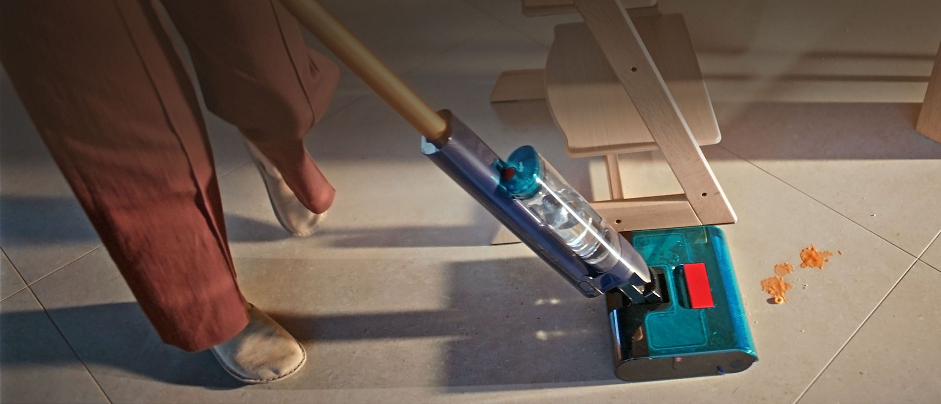 The Dyson Clean+Wash Hygiene hard floor cleaner cleaning around a table.