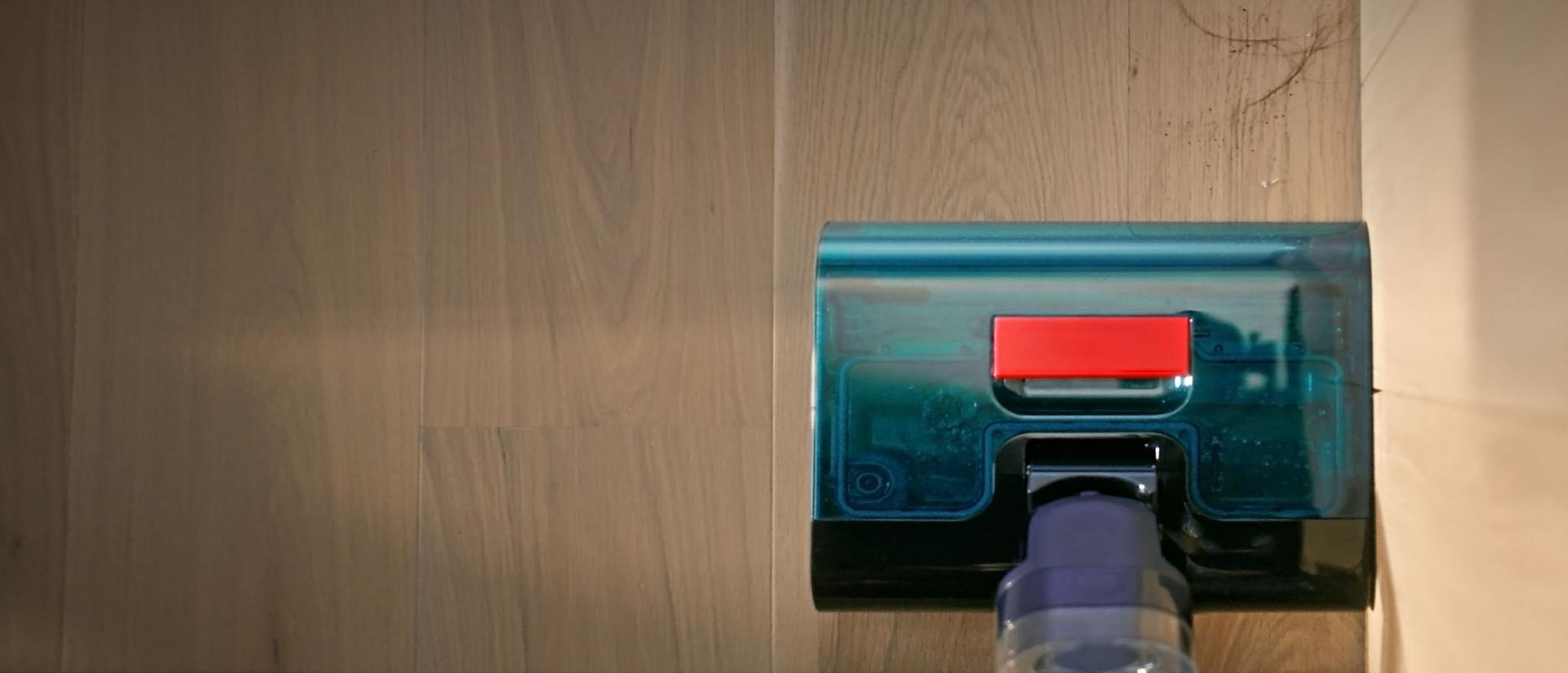 The Dyson Clean+Wash Hygiene hard floor cleaner cleaning to the edge of the wall.