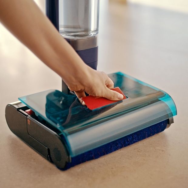 The unit is removed from the head of the Dyson Clean+Wash Hygiene hard floor cleaner.