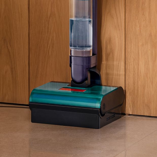 A docked Dyson Clean+Wash Hygiene hard floor cleaner.