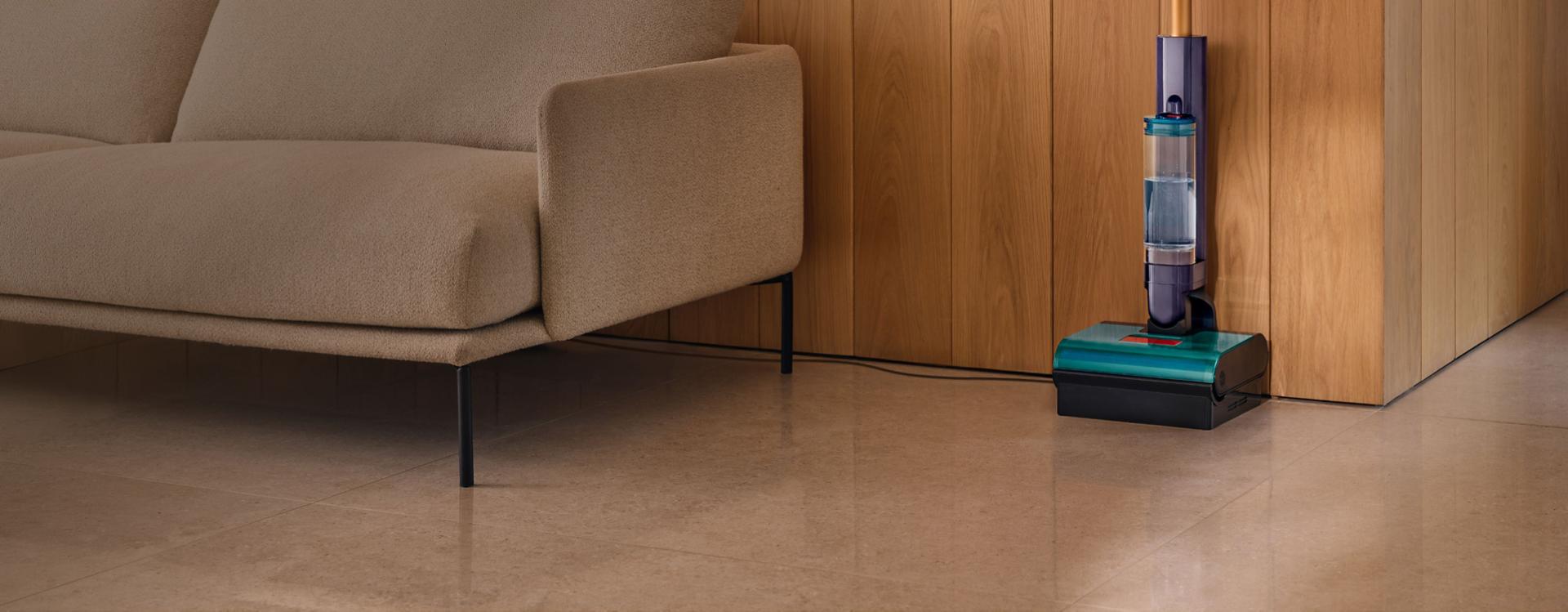 A docked Dyson Clean+Wash Hygiene hard floor cleaner.