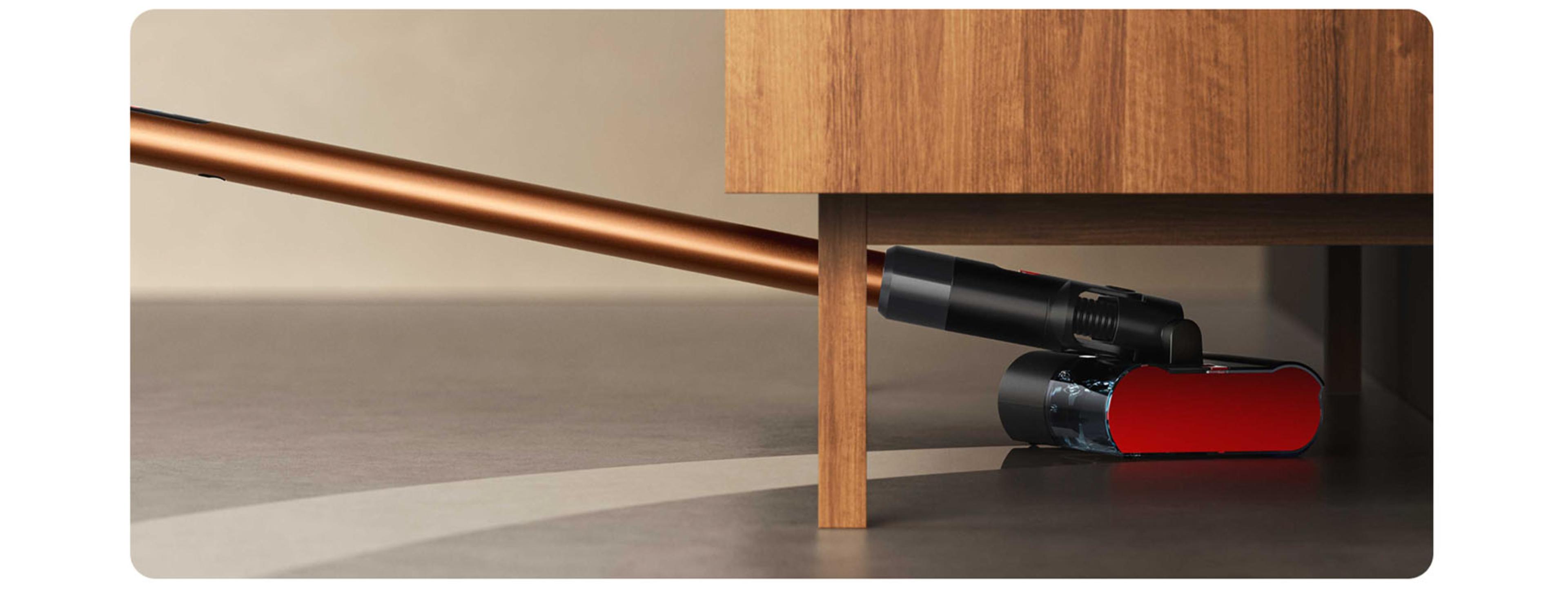 Dyson PencilWash vacuum Wet roller head led flat underneath a sideboard unit.
